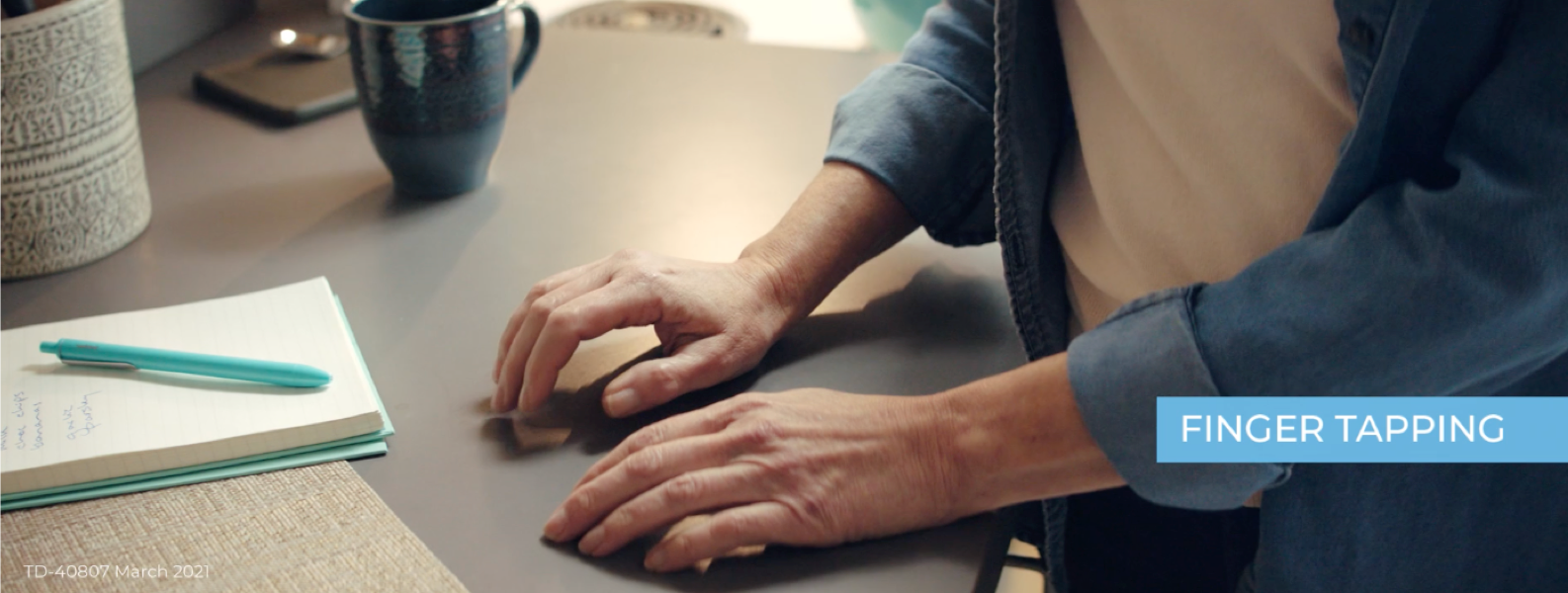 Woman experiencing finger tapping symptom of TD.