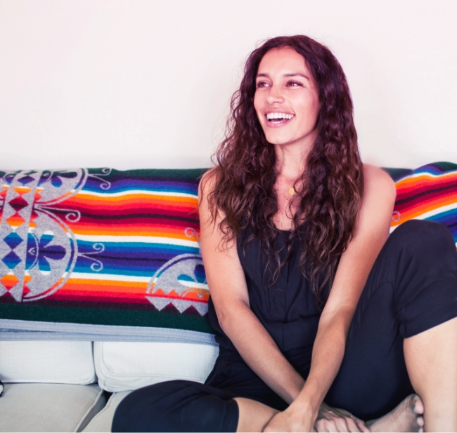 Woman smiling while sitting on a couch