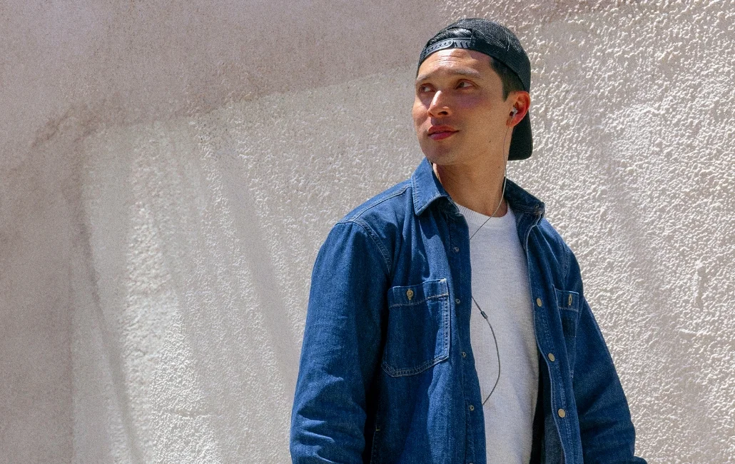 Close up of a man walking in front of a wall